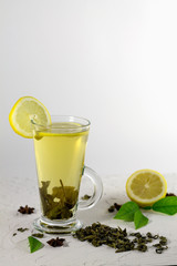 cold green tea with lemon and mint on white background
