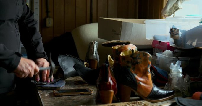 Woman Shoemaker making a par of shoes