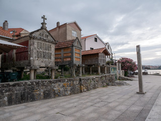 line of traditional granaries or horreos in the fishing village of Combarro, Spain