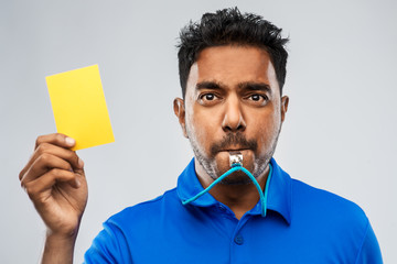 sport, caution, game and football concept - indian referee whistling and showing yellow card