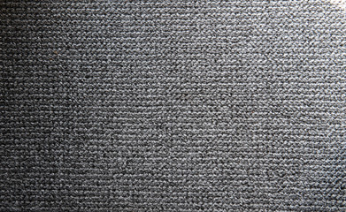 Grey and white fabric close up in the shadow and light. Background image.