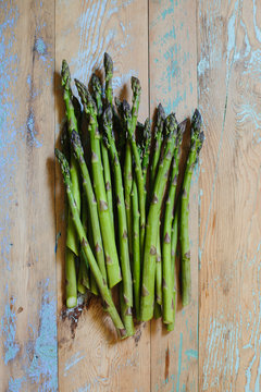 Bunch of fresh picked asparagus on rustic farm table