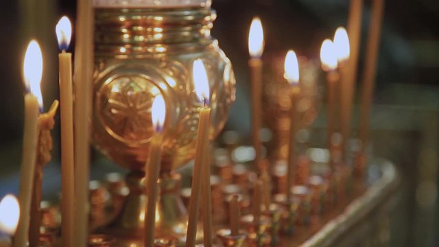 Candles on a candlestick in a church. Religious holiday.