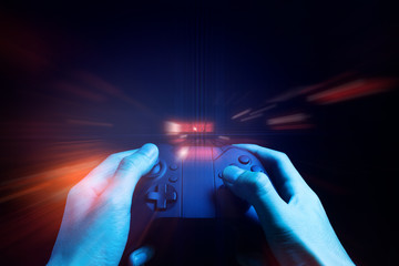 gamer boy with hand holding the joystick controller electronic for playing game with online network connection  technology device in esport tournament challenge concept © issaronow