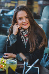 pretty woman at outdoors cafe eating salad