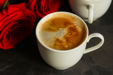 coffee in a white cup, bouquet red roses (gift, date or congratulation) menu concept. food background. copy space. Top view