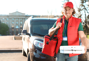 Male courier delivering food in city on sunny day