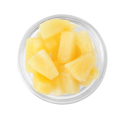 Bowl with pieces of delicious sweet canned pineapple on white background, top view