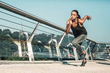 Fototapeta na wymiar Sportswoman gaining speed while running stock photo