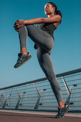 Sportswoman pulling her knee up stock photo