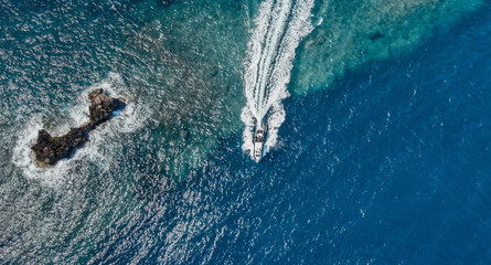 high speed outboard boat in the see seen from a drone