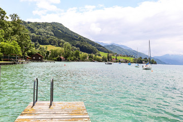 View to lake Attersee with sailing boat, Mountains of austrian alps near Salzburg, Austria Europe