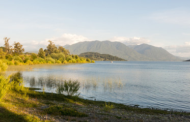 Fototapeta premium Serene panorama of the calm waters of Panguipulli Lake, from the village of Panguipulli. Patagonian area, Chile.