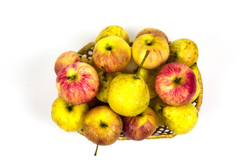 Top view of fresh apples pears in wicker basket with water droplets isolated on white background. Vegetables fruits. Useful product.
