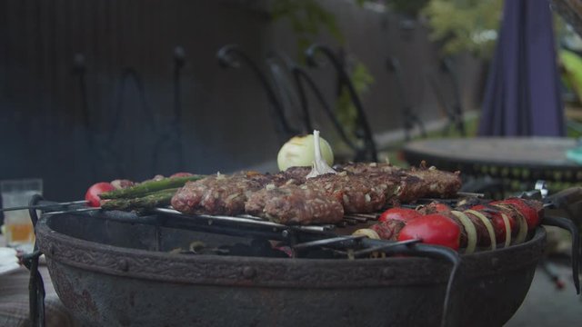 Outdoor grill with beef and vegatables in slow motion. 
