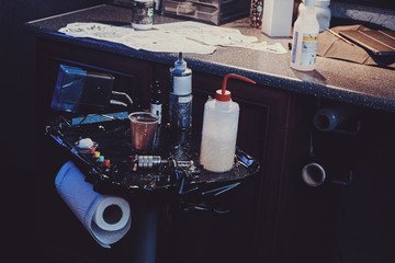 Necessary every tattoo master equipment - inks, water and tattoo machine.