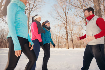 Group of woman doing exercise in winter snow