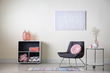 Stylish room interior with modern furniture and flowers near beige wall