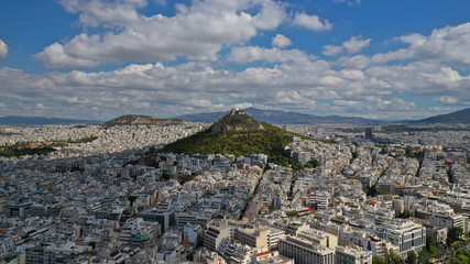 Aerial drone photo of iconic Mount Lycabettus featuring famous church of Saint George on top with...