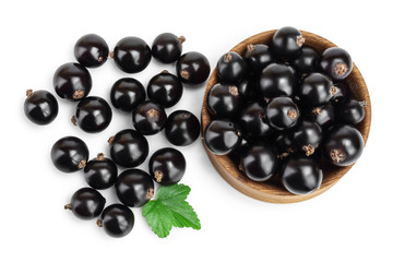 Black currants in bowl on white background.Top view. Flat lay pattern