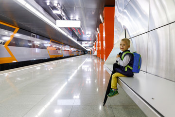portrait of a little citizen who is waiting for a metro train at the new Moscow metro station.