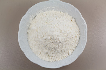 Flour in a white ramekin on a table
