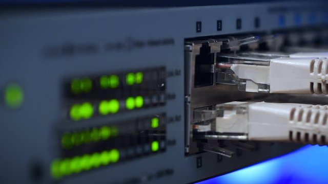 Rack focusing on Ethernet server switches in Data Center sending and receiving data over the Ethernet. 4K UHD Video.