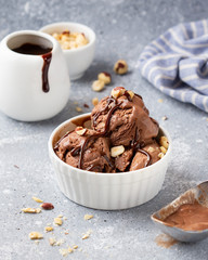 Chocolate ice cream with sauce and nuts, delicious summer dessert, sweet food
