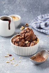 Chocolate ice cream with sauce and nuts, delicious summer dessert, sweet food