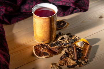 Hot mulled wine in a mug on a wooden table