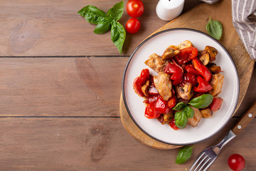 Fried chicken with vegetables (tomato, pepper, onion), mushrooms and Basil. Delicious dinner, healthy traditional food