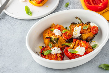 Bell peppers stuffed with meat, vegetables, and cheese.