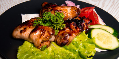 chicken wings with vegetables on a plate