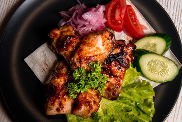 chicken wings with vegetables on a plate