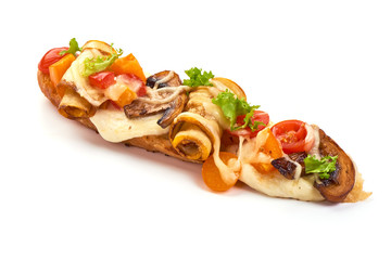 Spanish Tapas and Pinchos with champignon mushrooms, tomatoes, soft cheese slices and herbs, isolated on white background