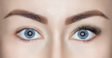 A beautiful woman with long eyelashes in one eye, and on the other, eyelashes are not extended....