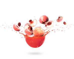 Whole and sliced peaches with splashes of fresh juice, isolated on white background © Krafla