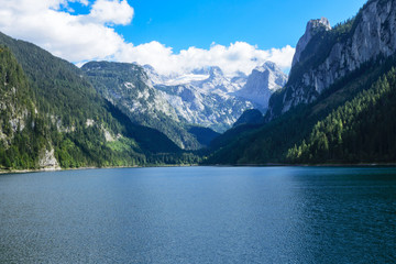 Lake, mountains with snow and forests in the region of Gosauseen, Austria.