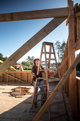 Fototapeta premium New home construction process, skilled roofer 
