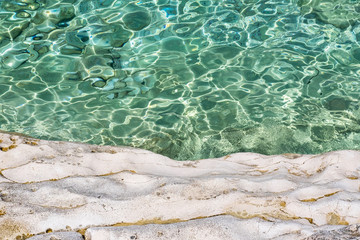 Stone beach on Proizd Island near Korcula Island, Dalmatia, Croatia, clear emerald sea water and stones, popular tourist destination  