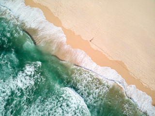 Fototapeta na wymiar Aerial Photography of Ocean With Person Walking on Beach