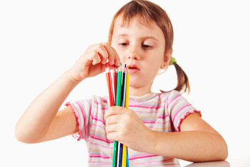 Child girl using colored pencils. Art, creative, talent, education,  happy childhood concept.