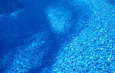 Ripples on the surface of an outdoor pool on a sunny day