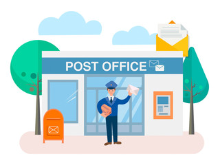 Postman with parcel and envelope at the door in the background of the post office building with a mailbox outside and ATM on the wall of the building.