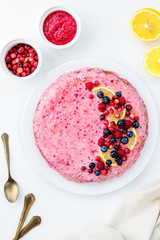 Cranberry pie with lemon on a white table. Top view, vertical orientation, closeup.