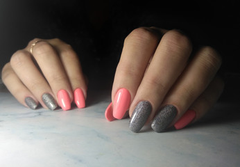 Colorful manicure with pink glossy finish. Long square nails with grey sequins design.