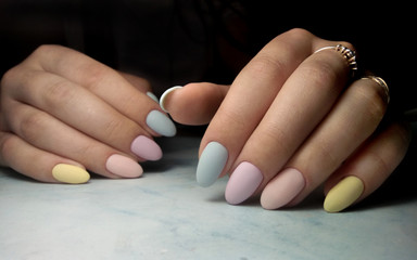 Colorful manicure with multi-colored coating. Long round nails with color matte design.