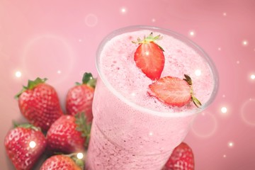 Glass of strawberry smoothie on wooden table
