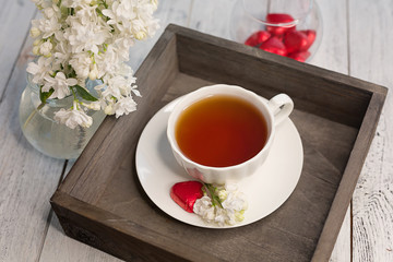 composition with a Cup of tea and lilac