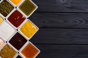 Set of different sauces in ceramic bowl